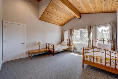 a bedroom with two beds and a wooden ceiling at Mountain & Lake-View Delight in Truckee