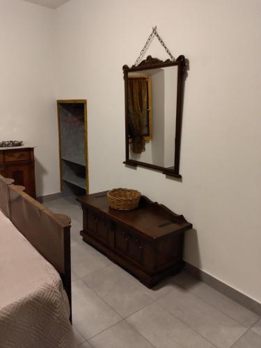 a bedroom with a dresser and a mirror on the wall at Settesette6 in Barghe