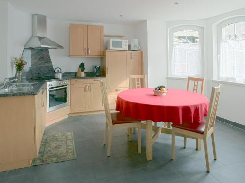 a kitchen with a table with a red table cloth on it at Haus Shangri-La in Saas-Fee