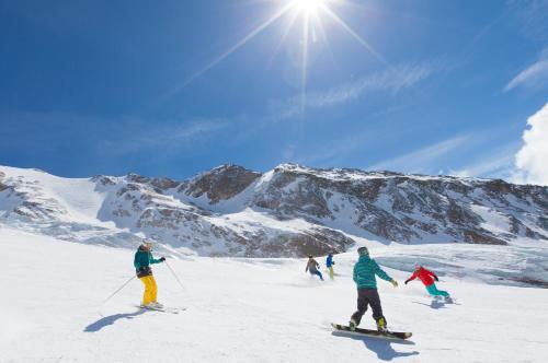 a group of people skiing down a snow covered mountain at Haus Shangri-La in Saas-Fee