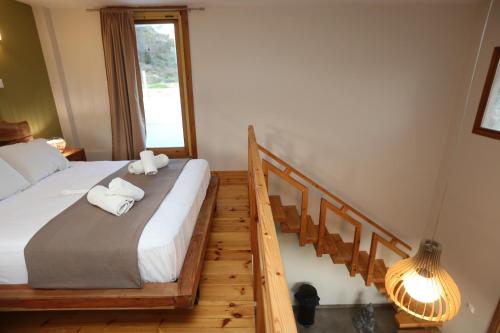 a bedroom with a bed with two towels on it at Picollo Grecia Residence Panoramic View in Ermoupoli