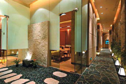 a hallway of a hotel with a lobby with a table at Marco Polo Xiamen in Xiamen