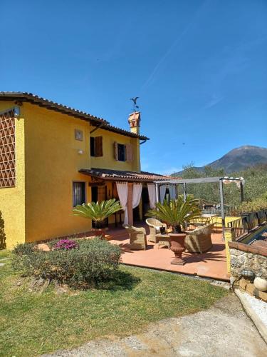 a house with a patio with a swing at Villa Daniela in Camaiore