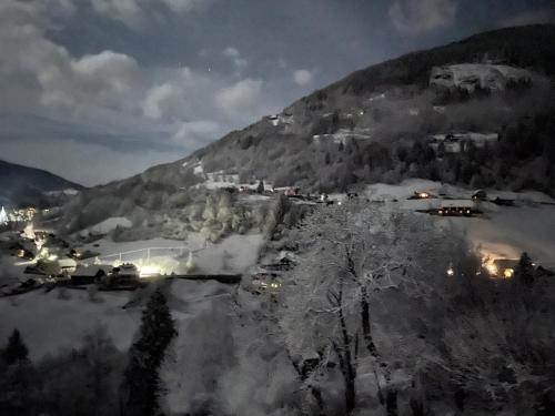 a village in the snow at night at Landhaus Schönblick in Radenthein