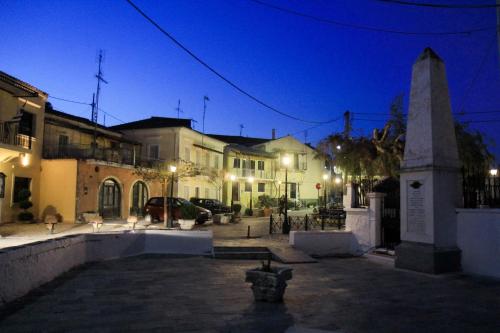 a monument in the middle of a street at night at Rodia in Kynopiástai