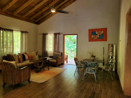 a living room with a couch and a table at Ecoscape Jamaica - Cottages by the river in Ocho Rios