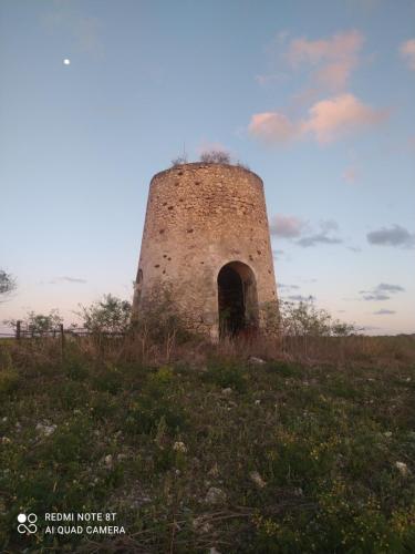 an old brick tower on a grassy hill at Kaz a Klemence Gite creole avec piscine et table dhotes a Anse Bertrand in Anse-Bertrand