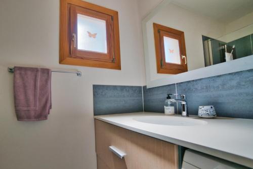 a bathroom with a sink and a mirror at Casa Abeja in Colonia de Sant Pere