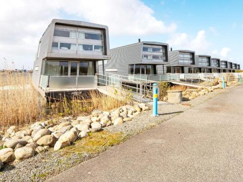 a flock of sheep in front of a building at 6 person holiday home in Hemmet in Falen