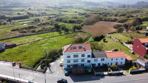 an aerial view of a white house with a red roof at Playa de Barrañan in Arteixo