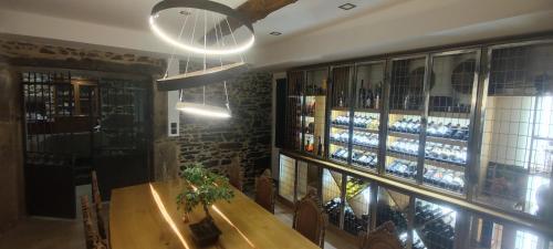 a dining room with a table and some bottles of wine at Casa do pato 2 in Peso da Régua
