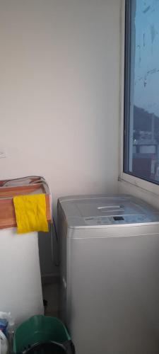 a small refrigerator in a room with a window at Hogar dulce hogar in Cartagena de Indias