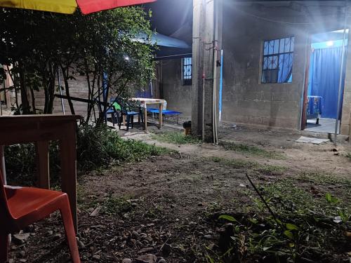 an outside area of a building with a table and benches at Casa " MARY " in Lanquín