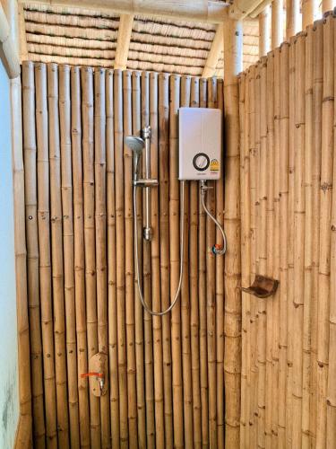 a bamboo wall with a shower in a room at สวนเกษตรรักษ์ไผ่ Bamboo Conservation Farm in Surin