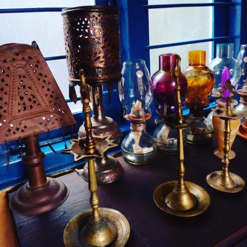 a table with different types of glass bottles on it at Eco Village Yoga Home in Digana
