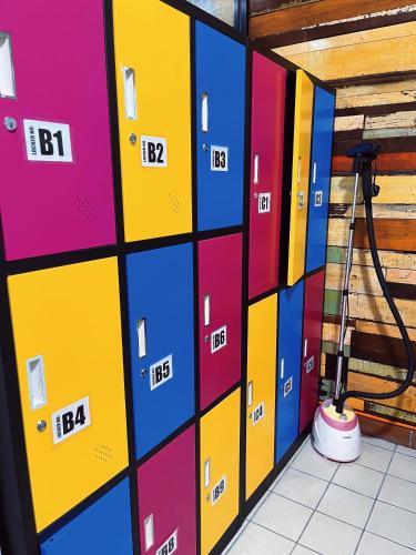 a row of colorful lockers in a room at ZZZ SLEEP MODE CAPSULE in Skudai