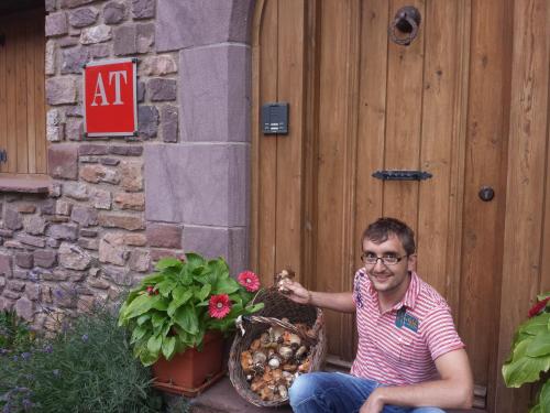 a man sitting in front of a wooden door at Apartamentos Chuandervera in Laspaúles
