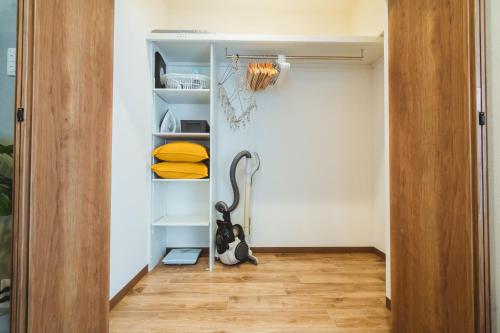 a room with a closet with a cat sitting on the floor at City Hideout in Tokyo