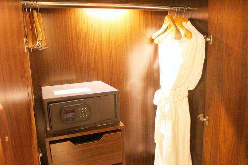 a bathroom with a tv and a curtain on a door at Beijing Continental Grand Hotel in Beijing
