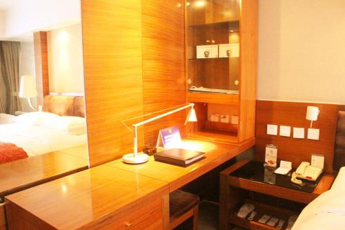 a desk in a hotel room with a bed and a desk at Beijing Continental Grand Hotel in Beijing