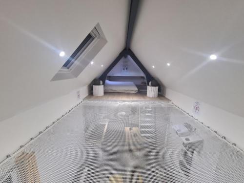 a large bird cage in a room with a bed at loft SPA nature et détente in Messy