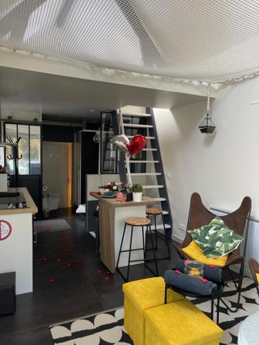 a kitchen and living room with a loft conversion at loft SPA nature et détente in Messy