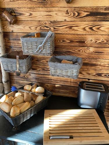 a wooden table topped with a basket filled with bread at Family Apartments Lübeck in Lübeck