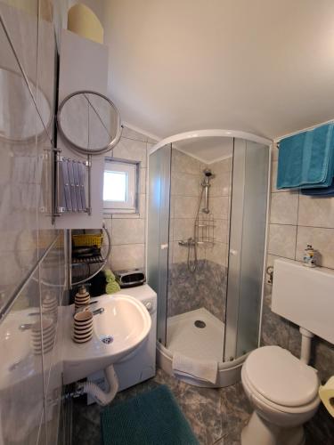 a bathroom with a shower and a toilet and a sink at Holiday Home Ulika in Fažana