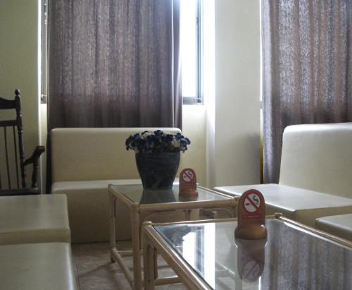 a living room with a table, chairs and a coffee table at Hotel Marko in Loutraki
