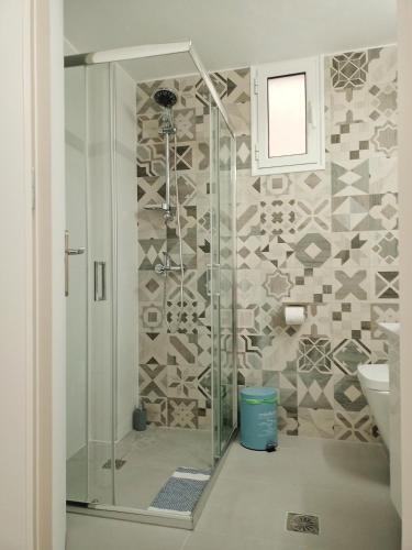 a bathroom with a shower with a toilet and a sink at Marw's home in Nafplio