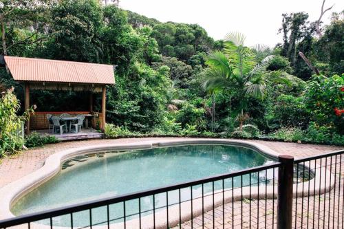 a small swimming pool next to a fence at Studio in the Rainforest in Kuranda
