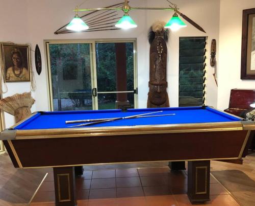 a pool table in the middle of a room at Studio in the Rainforest in Kuranda