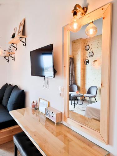 a living room with a mirror and a couch at Penélope Hotel in Ialyssos