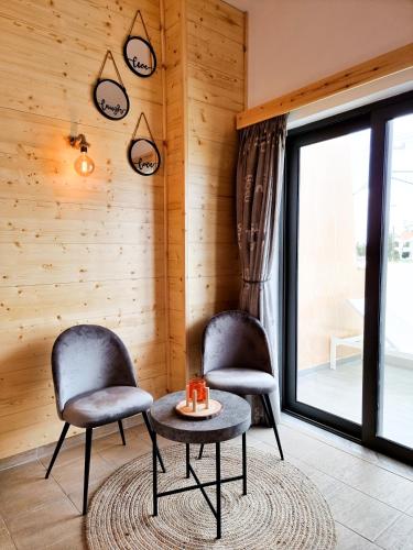 two chairs and a table in a room at Penélope Hotel in Ialyssos