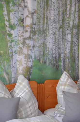 a bedroom with a mural of aspen trees at Ferienwohnung Fahrner in Baiersbronn