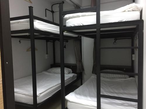 a row of bunk beds in a room at Backpack Station in Bangkok