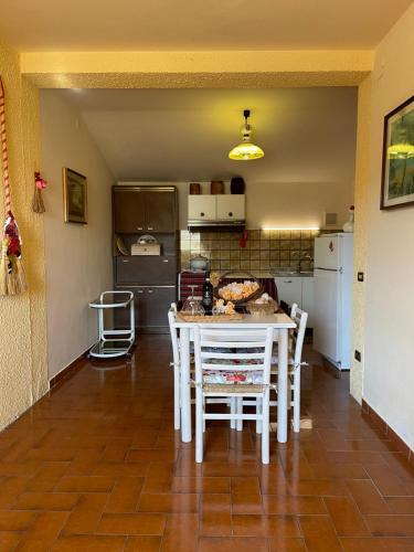 a kitchen with a table and chairs in a room at Il Girasole in Marti