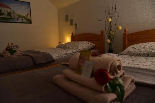 a bedroom with two beds with towels on the floor at Apartment Bobic in Ličko Petrovo Selo