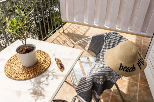 a hat sitting on a table with a plant on it at Skiathos Thalassa, Philian Hotels and Resorts in Skiathos Town