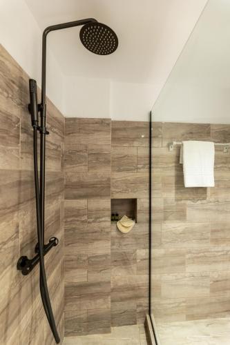 a shower with a glass door in a bathroom at Skiathos Thalassa, Philian Hotels and Resorts in Skiathos Town