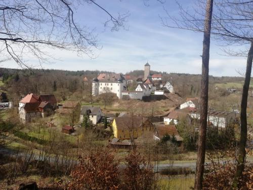 a small village with a church on a hill at Ferienhaus am Schloss, Haag 127 in Aufseß