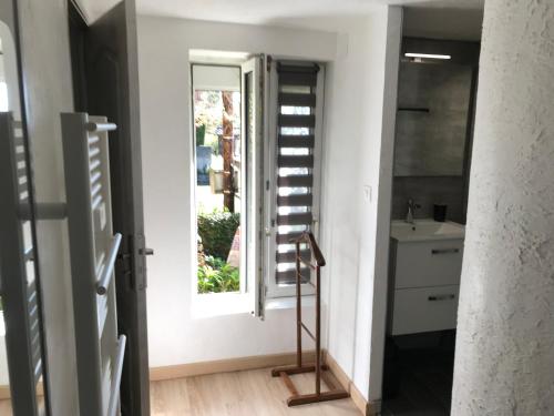 a bathroom with a window and a sink at Le Clos d'Auré. in Oberhaslach