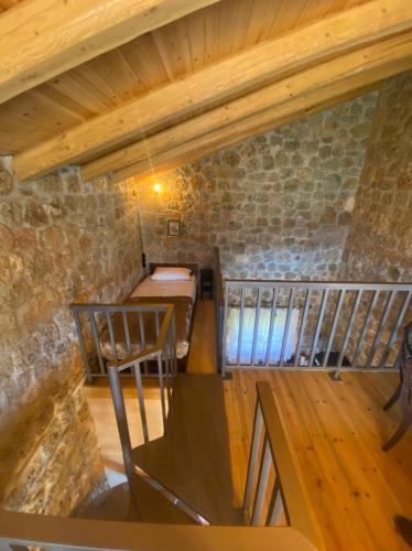 an attic room with a table and a chair at Angelic in the mountains in Kaisárion