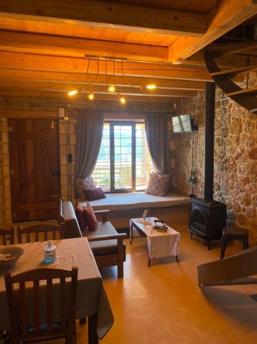 a living room with a couch and a stove at Angelic in the mountains in Kaisárion