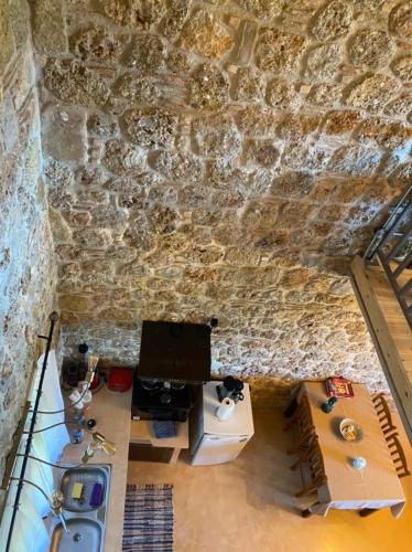 an overhead view of a room with a stone wall at Angelic in the mountains in Kaisárion