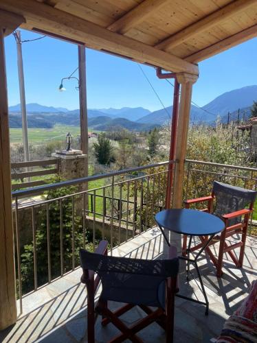 a balcony with a table and chairs and a view at Angelic in the mountains in Kaisárion