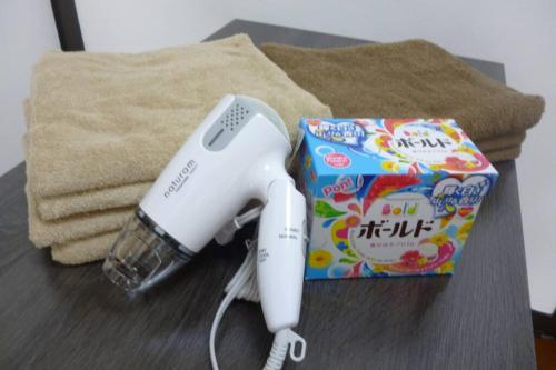 a nintendo wii game system sitting next to a box at 2-2札幌駅徒歩7分の好立地Service Apartment SAPPORO札幌ステーション綺麗な部屋 in Kita-rokujō