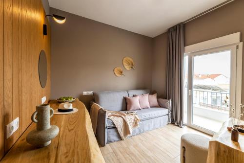 a living room with a couch and a table at Skiathos Theros, Philian Hotels and Resorts in Skiathos Town