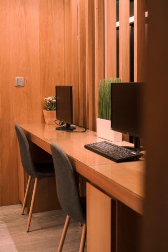 a desk with a computer and two monitors on it at Hub Hotel Kaohsiung Yawan Branch in Kaohsiung