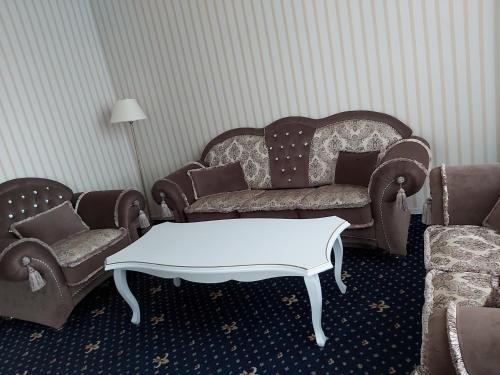 a living room with a couch and a coffee table at "Palazzo" in Kostanay